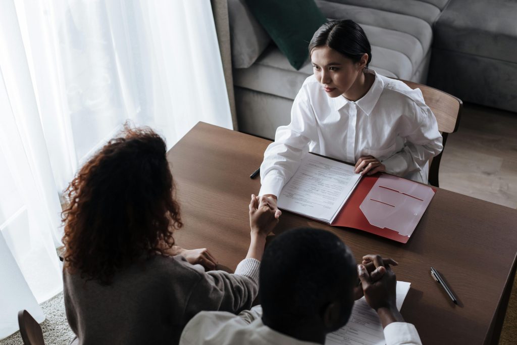 Workers shaking hands across table